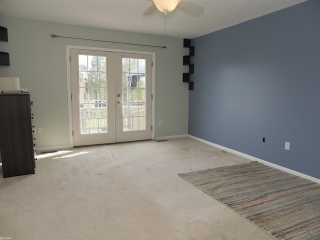 interior space with baseboards, carpet flooring, french doors, a ceiling fan, and visible vents