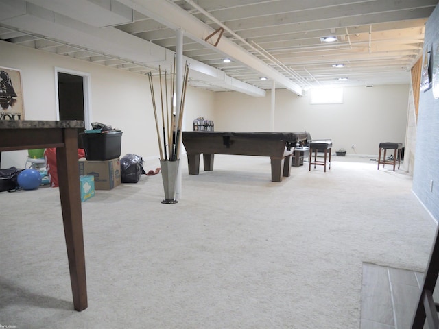 below grade area with pool table and carpet flooring