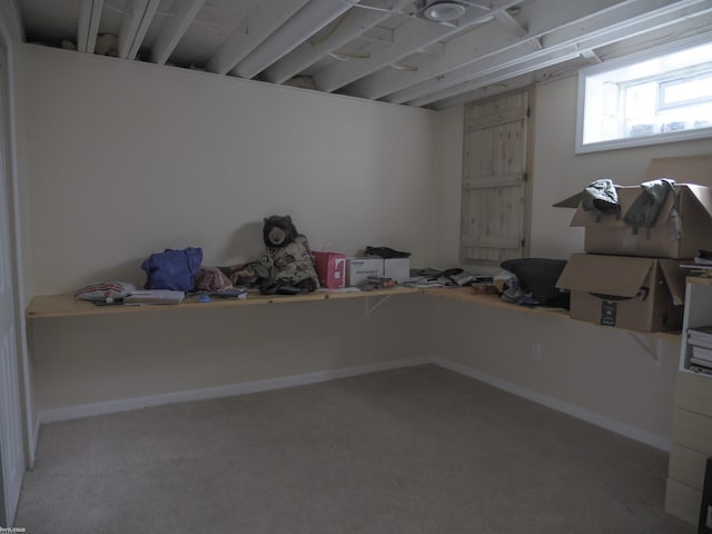 below grade area featuring carpet floors and baseboards