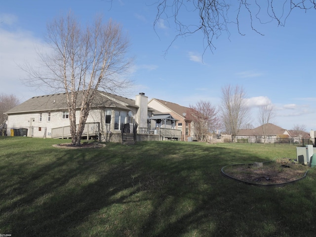 view of yard featuring fence and a wooden deck