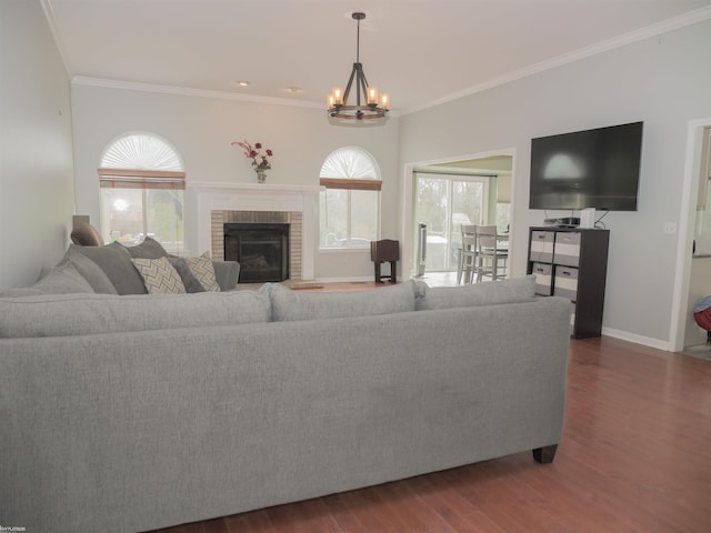 living room featuring a chandelier, baseboards, ornamental molding, and wood finished floors