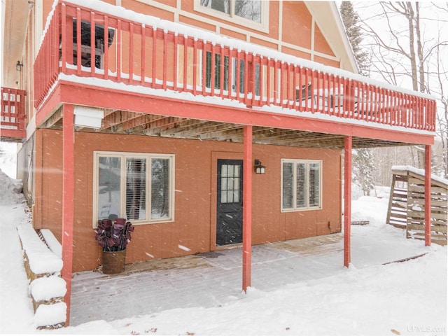 102 Big Bear Rd, Iron River, MI 49935 - snow covered house with a wooden deck