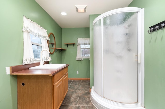 full bath with visible vents, baseboards, vanity, and a stall shower