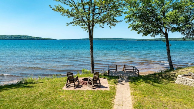 property view of water with an outdoor fire pit