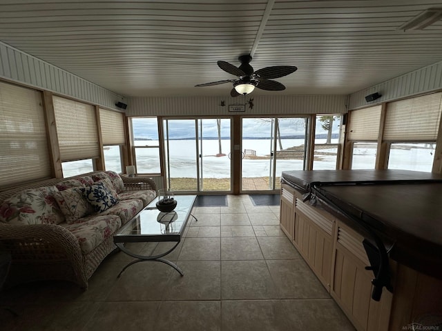 living area with light tile patterned floors and a ceiling fan