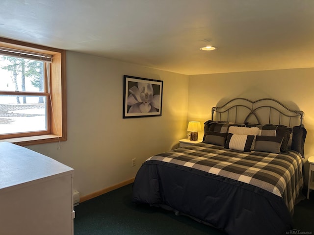 carpeted bedroom featuring baseboards