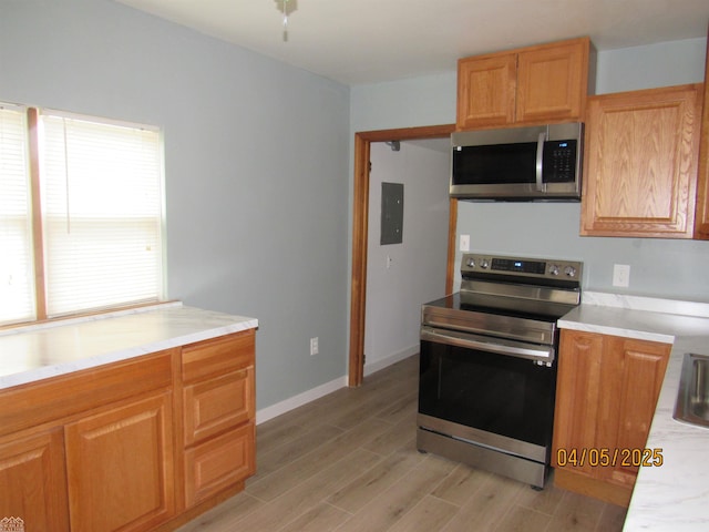 505 Washington St, Marine City, MI 48039 - kitchen with appliances with stainless steel finishes, light wood finished floors, light countertops, and baseboards