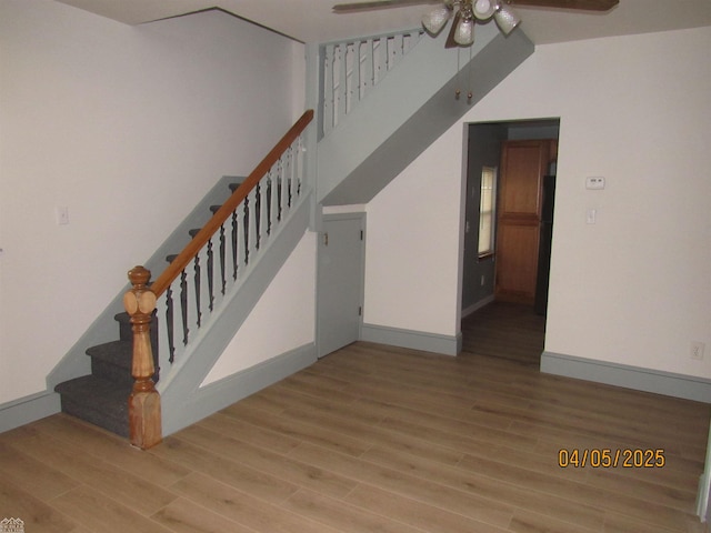 505 Washington St, Marine City, MI 48039 - staircase featuring wood finished floors, a high ceiling, a ceiling fan, and baseboards