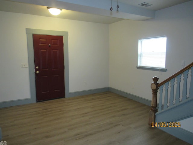 505 Washington St, Marine City, MI 48039 - entrance foyer with wood finished floors, baseboards, visible vents, and stairs