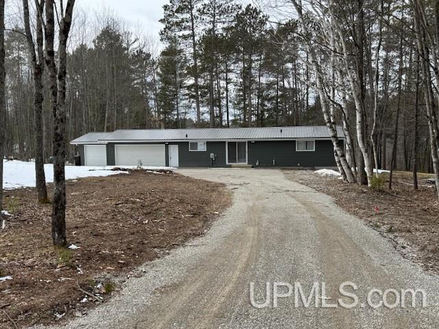 single story home featuring driveway and an attached garage