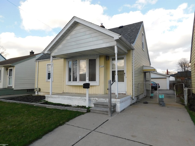 27324 Larchmont St, Saint Clair Shores, MI 48081 - bungalow-style home with an outbuilding, a shingled roof, and a detached garage
