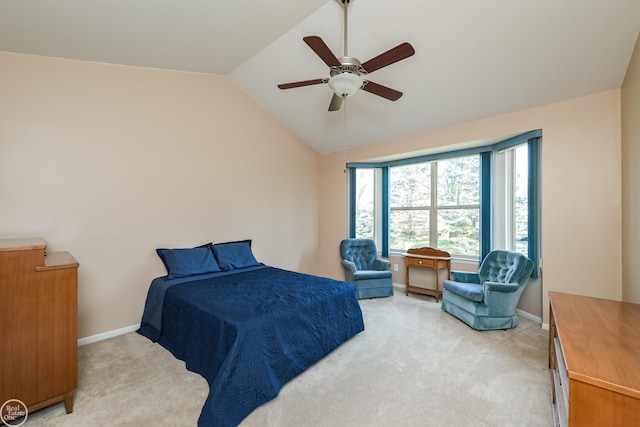 bedroom featuring baseboards, light colored carpet, vaulted ceiling, and ceiling fan