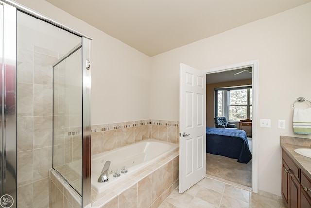 bathroom with a whirlpool tub, vanity, a stall shower, tile patterned floors, and connected bathroom