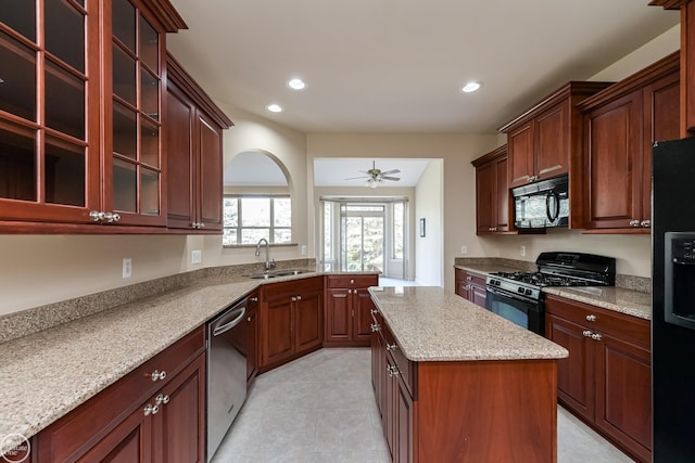 kitchen featuring recessed lighting, a center island, black appliances, ceiling fan, and a sink