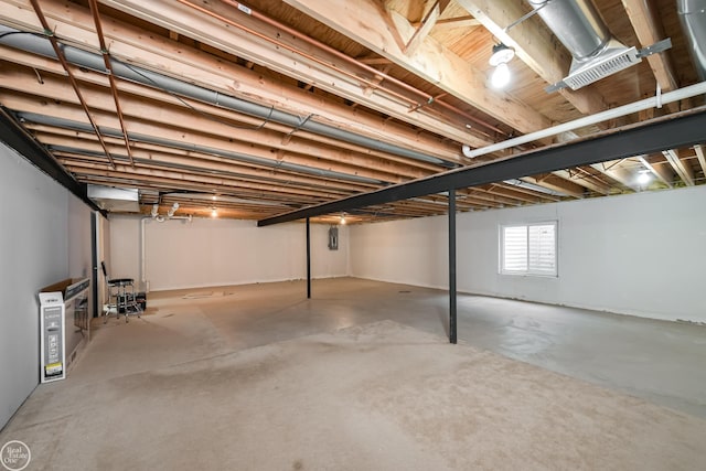 basement featuring visible vents and electric panel