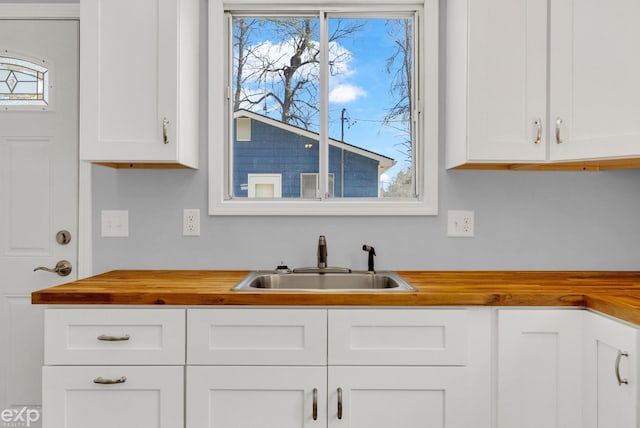 2407 Karen St, Prescott, MI 48756 - kitchen with a sink, wooden counters, and white cabinetry