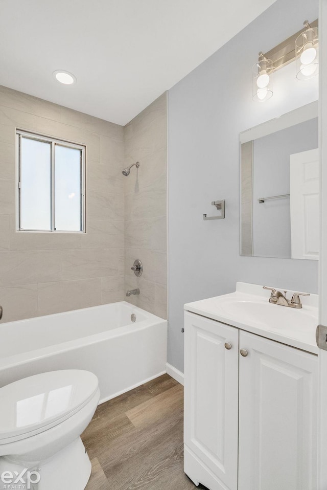 2407 Karen St, Prescott, MI 48756 - full bathroom with toilet, wood finished floors, vanity, and shower / tub combination