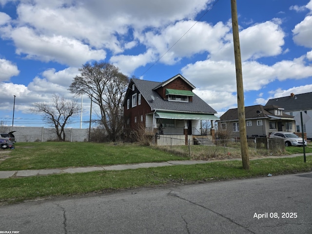 view of front of property with a fenced front yard and a front lawn