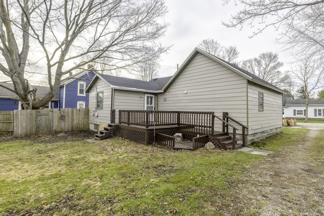 7173 Lake St, Lexington, MI 48450 - rear view of house with fence, a wooden deck, a shingled roof, and a yard