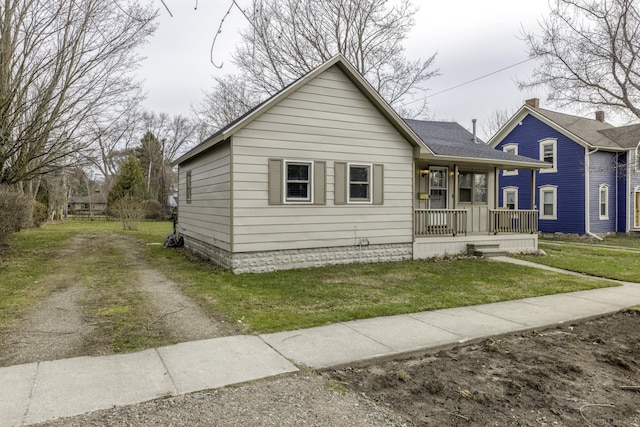 7173 Lake St, Lexington, MI 48450 - bungalow-style home featuring a porch, a front yard, and roof with shingles