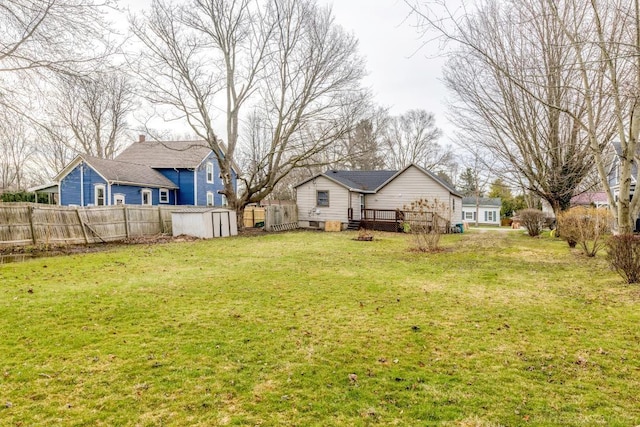 7173 Lake St, Lexington, MI 48450 - view of yard with fence, a storage shed, a wooden deck, and an outbuilding
