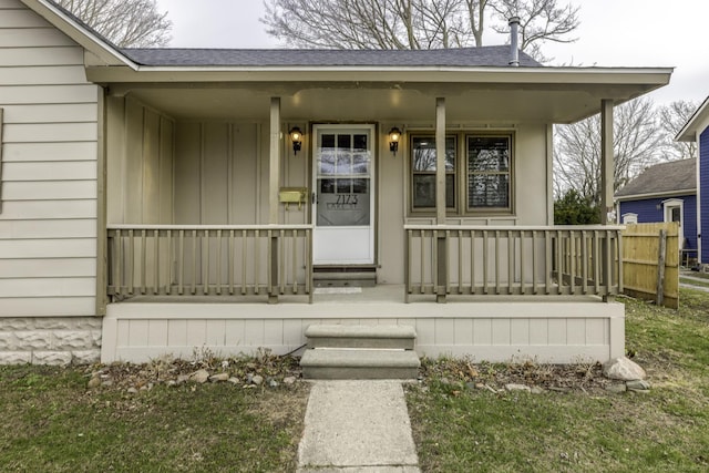 7173 Lake St, Lexington, MI 48450 - property entrance with board and batten siding, fence, covered porch, and roof with shingles