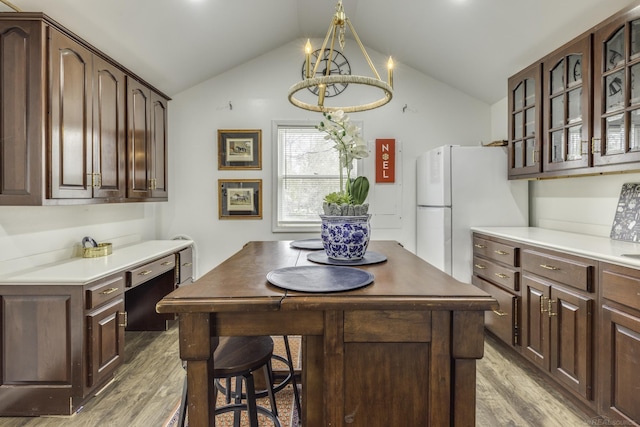 7173 Lake St, Lexington, MI 48450 - kitchen with dark brown cabinets, glass insert cabinets, lofted ceiling, and light wood finished floors