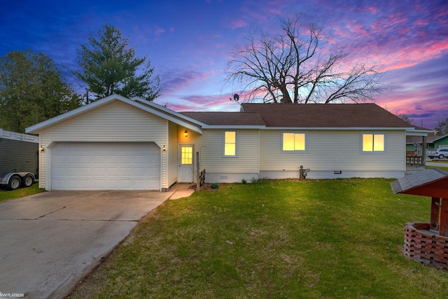 ranch-style house featuring crawl space, a garage, concrete driveway, and a lawn