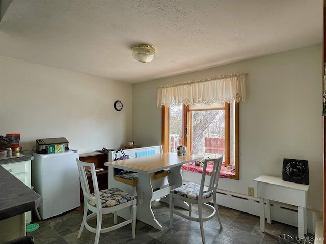 1215 Dakota Ave, Gladstone, MI 49837 - dining space featuring washer / dryer, dark stone finish flooring, and a textured ceiling