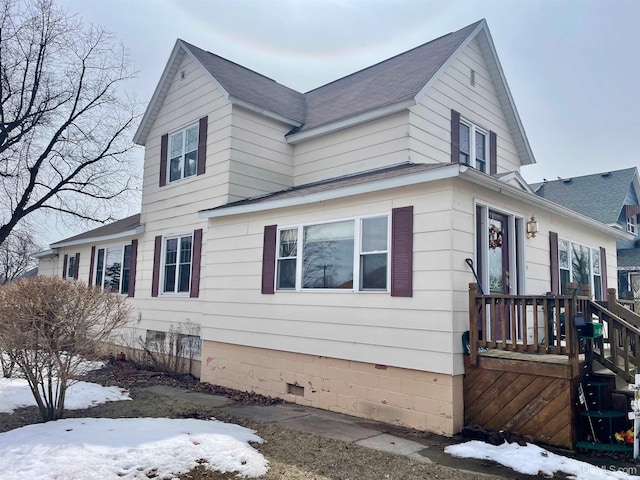 1215 Dakota Ave, Gladstone, MI 49837 - view of snowy exterior with a shingled roof