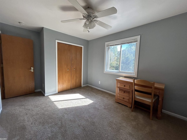 unfurnished bedroom featuring a closet, baseboards, carpet flooring, and ceiling fan