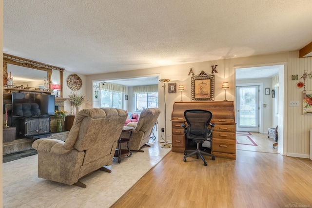 living area with a textured ceiling and light wood-type flooring