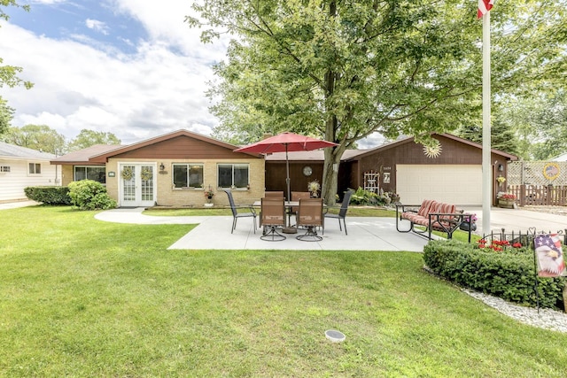 rear view of house featuring a yard, a patio, fence, french doors, and a garage