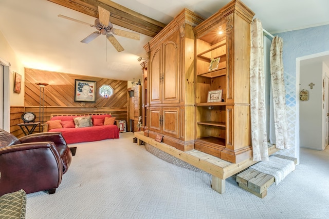 living room with wood walls, carpet, ceiling fan, and lofted ceiling