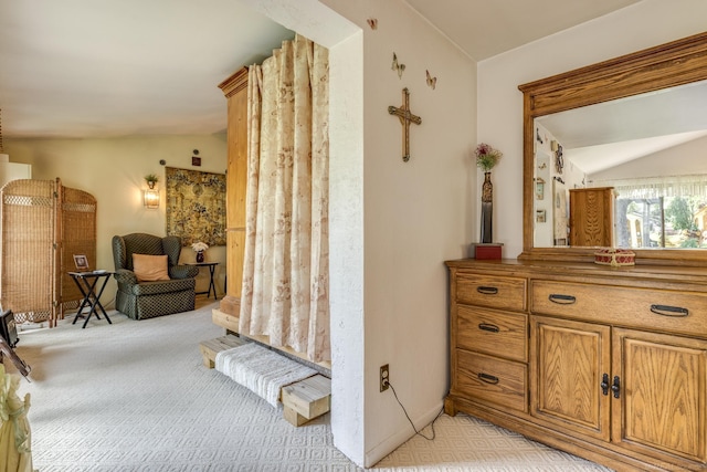 interior space featuring light colored carpet and lofted ceiling
