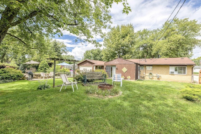 view of yard featuring a fire pit and a patio