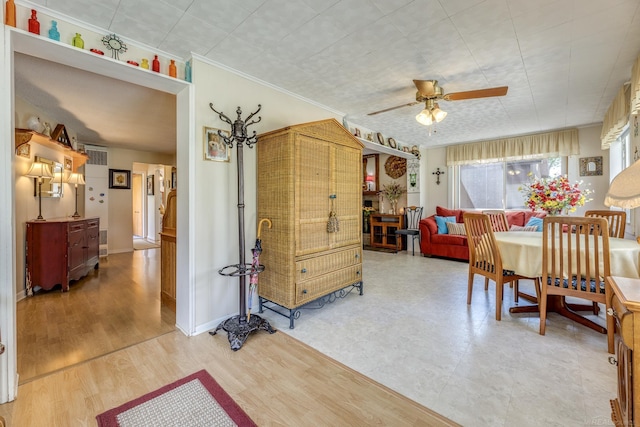 dining area featuring crown molding and ceiling fan