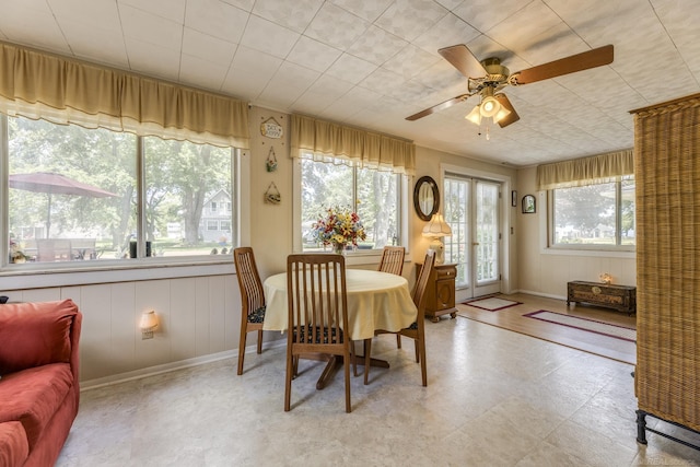 dining area with ceiling fan and baseboards