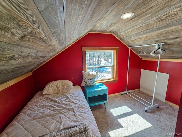 carpeted bedroom with baseboards, wooden ceiling, and vaulted ceiling