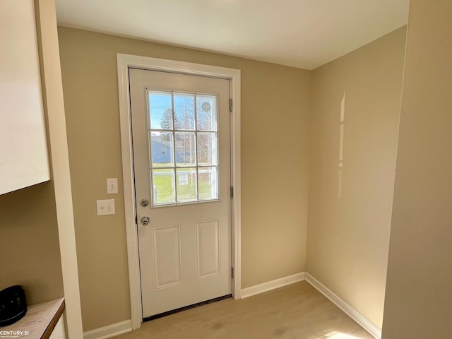 entryway featuring light wood-style flooring and baseboards