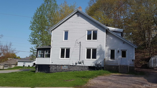 view of side of home featuring a yard and a chimney