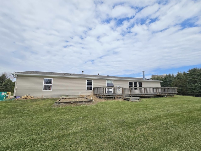 back of property with a yard and a wooden deck