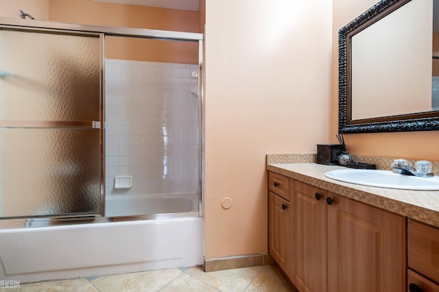 full bathroom with vanity, tile patterned flooring, and bath / shower combo with glass door