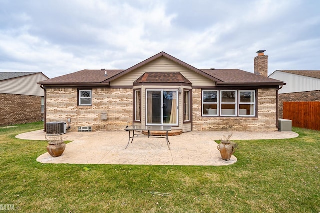 rear view of property with a patio, brick siding, fence, and a lawn