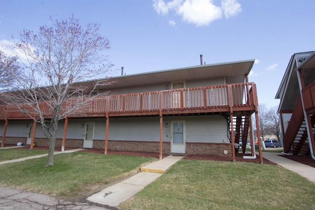 view of front of house with a front yard, stairway, and a deck