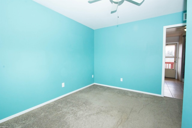 unfurnished room featuring visible vents, baseboards, a ceiling fan, and carpet flooring