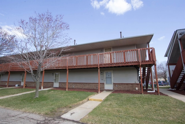 view of front facade with a front lawn, stairway, and a deck