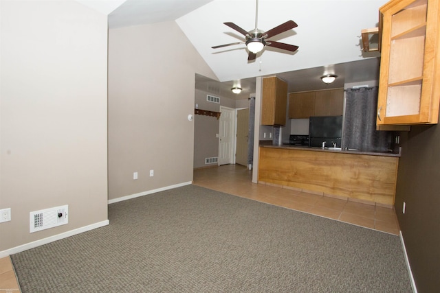 unfurnished living room with visible vents, carpet floors, and ceiling fan