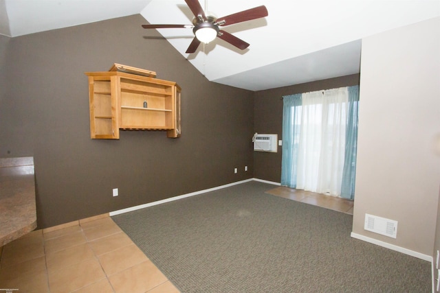 tiled empty room with lofted ceiling, baseboards, a wall mounted air conditioner, visible vents, and ceiling fan