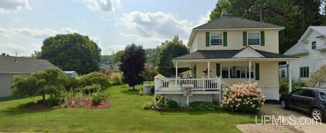 country-style home with a front yard and a porch
